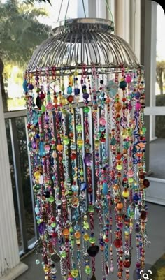 a birdcage filled with lots of colorful beads