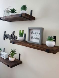 two wooden shelves with plants and signs on them, one is displaying the family's happy home