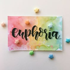 a colorful card with the word euphria written in cursive ink