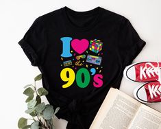 This t-shirt is the perfect choice for anyone attending an 90s-themed party or event. The shirt features a crew neck and short sleeves, making it a comfortable option for any occasion. The graphic tee design showcases the phrase "This Is My 90s Costume" in a fun and festive font. Made from soft and durable cotton jersey fabric, this regular fit t-shirt is machine washable for easy care. Whether you're dressing up for a wedding, party, or simply casual wear, this t-shirt will be a hit. So channel your inner 90s vibe and make a statement with this must-have piece. Size Chart is given in the listing pictures! Washing Care  Wash your garment inside out at low temperature (30 degrees) and always wash with cold water. Do not tumble dry or iron on the print.  Service We take pride in our work and Cheap 90s Style Shirt With Graphic Print, Cheap Multicolor 90s Style T-shirt, 90s Style Stretch T-shirt, Cheap 90s Inspired Graphic T-shirt, Cheap 90s Inspired Summer Shirt, Cheap 90s Style T-shirt With Sublimation Print, Cheap 90s Style Shirt With Text Print, Cheap 90s Style T-shirt For Fan Conventions, Affordable 90s Inspired Screen Print T-shirt