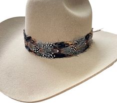 Introducing our latest accessory - the Falcon Western Hat Band! Elevate your hat game with this unique and stylish addition, featuring a mix of black, brown, and white feathers that will perfectly complement any western hat. The band is adjustable with a sturdy leather tie, ensuring a comfortable fit for all sizes. Whether you're hitting the rodeo or just want to add some flair to your everyday look, this hat band is sure to turn heads. Don't miss out on this must-have accessory! Feather Hat Band, Cowboy Hat Band, Colored Feathers, Hat Burning, Boho Hats, Cowboy Hat Bands, Crazy Hat, Coloured Feathers, Leather Craft Projects