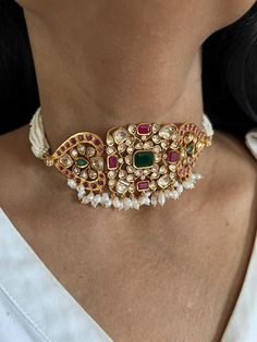 Simply a mark of royalty and elegance! You will definitely fall in love with the beautifully placed multicolored Kundan stones, One of our favorite picks for the wedding season. Do notice the beautiful pink beads in the pearl strings. Material: Copper Brass and silver mix, with gold plating Premium quality Choker Necklace Dimensions: Weight: 45 grams. Closure Type: Premium Adjustable Dori Earring Dimensions (Per Pair): Weight: 12 grams Length: 4.5 cm Width: 2 cm Closure Type: Push Back Closure with Extra Support Clip at the Back. Elegant Multi-stone Bridal Necklace For Festive Occasion, Elegant Multi-stone Bridal Necklace For Festivities, Elegant Festive Multi-stone Bridal Necklace, Elegant Kundan Multi-stone Jewelry, Elegant Multicolor Multi-stone Bridal Necklace, Elegant Multi-stone Jewelry For Festivals, Pearl Beaded Jewelry For Reception, Pearl Beaded Jewelry For Receptions, Elegant Multicolor Jewelry For Festive Occasions