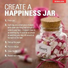 a jar filled with pink and white candies on top of a wooden table next to string