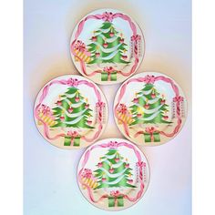 four plates decorated with christmas trees and bows