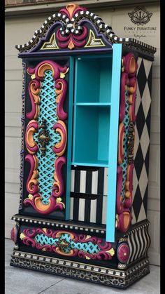 an ornate painted cabinet is on display in front of a building with a checkered wall