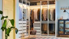 an organized closet with clothes hanging on shelves and shoes in the bottom drawer, next to a door