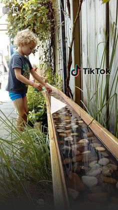 a little boy that is playing with some rocks