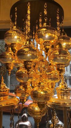 a large chandelier is hanging from the ceiling in front of a store window