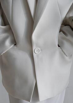 Color: White Midweight suiting fabric Oversized silhouette Padded shoulders Peak lapels Illusion welted breast pocket Flap front pockets Single button front closure Back vent hem Lined 100% Polyester Dry Clean By The Frankie Shop. Imported Suiting Fabric, The Frankie Shop, Frankie Shop, Ideal Wedding, Oversized Silhouette, White Blazer, The Trend, Pocket Detail, Button Detail