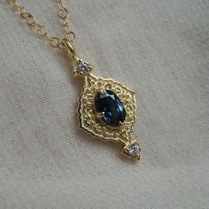 Introducing our stunning Cairo-inspired Blue Sapphire Necklace, a captivating homage to the architectural splendor and artistic finesse of the enchanting city of Cairo. Drawing inspiration from the intricate decorations adorning Cairo's historic buildings. At the heart of the necklace gleams a magnificent blue sapphire, evoking the serene depths of the Nile River as it winds its way through the bustling streets of Cairo. Upon closer inspection, one can find tiny floral motifs, meticulously craft Cairo Drawing, Ceremonial Oval Pendant Elegant Jewelry, Heirloom Blue Necklaces For Weddings, Elegant Sapphire Jewelry With Intricate Design, Luxury Blue Jewelry With Intricate Design, Exquisite Blue Jewelry With Intricate Design, Heirloom Sapphire Jewelry With Intricate Design, Art Deco Gold Sapphire Jewelry, Ceremonial Blue Jewelry With Intricate Design