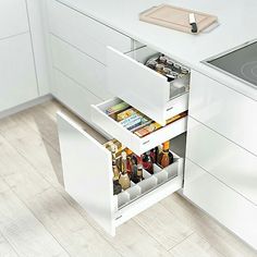 an open drawer in the middle of a kitchen