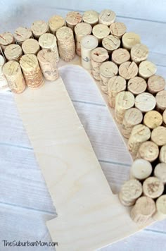 a wooden letter made out of wine corks