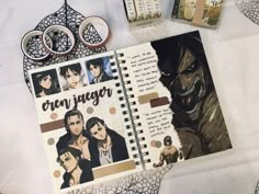 an open notebook with pictures of people on it next to some scissors and other items