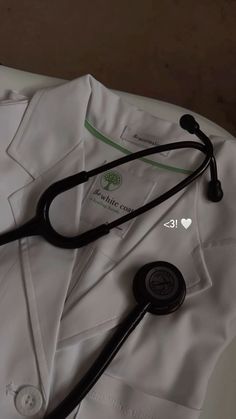 a stethoscope laying on top of a white shirt