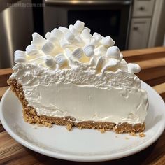 a piece of cake sitting on top of a white plate with marshmallows