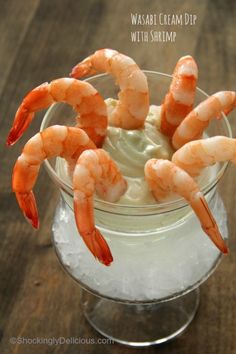 a glass bowl filled with whipped cream and shrimp