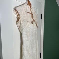 a white dress hanging up on a door