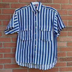 This is a super rad men's 80s shirt. White and blue striped short sleeve. 2 large pockets on the chest.  💯 % Cotton! Very breathable. Small discoloration spot/yellow (not stain treated yet) on right pocket (see pic). Not very noticeable, actually hard to photograph it 😂 This is unisex.  Gives me total summer vibes. Let's get on yacht 🛥 and sail away baby! Labeled a size small. Measurements as follows: Pit to pit laying flat 20" inches  Length is 27" in the front and 29" in the back  I ship pr Striped Collared Cotton Camp Shirt, Relaxed Fit Short Sleeve Cotton Shirt With Vertical Stripes, Striped Short Sleeve Cotton Shirt With Relaxed Fit, Striped Cotton Short Sleeve Shirt Relaxed Fit, Casual Collared Short Sleeve Shirt With Vertical Stripes, Striped Cotton Camp Shirt With Short Sleeves, Casual Short Sleeve Shirt With Vertical Stripes, Striped Collared Shirt With Pockets, 90s Cotton Collared Shirt