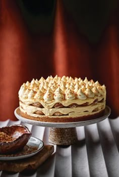 a cake sitting on top of a white plate next to other desserts and pastries