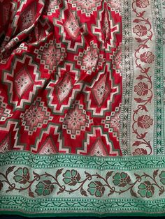 Stunning Semi Banarasi Silk Saree in Ikkat design with Paithani Style Borders in Red and Green combination. Item : SareeBase Fabric : Banarasi Silk Color : Red and Green Blouse piece : Comes with un-stitched Blouse piece.Blouse material :Banarasi Silk Work : HandloomFall & Edging(Yes/No) : Yes Disclaimer -:- Color variation is possible due to various reasons like phone or desktop setting, resolution etc. Please don't hold us responsible. Our aim is to put the exact color of the Saree.- If the Saree is Pure Silk, we will put it very clearly in our listing that it is Pure Silk. If we do not mention its Pure Silk please do not assume it is Pure Silk. When in doubt please feel free to check with us.- Thread coming out or zari coming out is NOT considered as a defect.- Since this Saree is handm Red Jamawar Traditional Wear With Motifs, Red Traditional Wear With Motifs In Jamawar, Red Jamawar Saree With Motifs, Red Paithani Silk Traditional Wear With Motifs, Red Banarasi Silk Traditional Wear With Motifs, Traditional Red Jamawar Saree, Red Meenakari Traditional Wear For Transitional Season, Red Jamawar Traditional Wear For Transitional Season, Red Paithani Silk Dupatta For Navratri