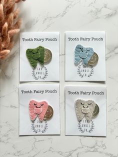 four tooth fairy pouches on a marble surface