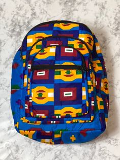 With bold colors and patterns these book bags will be the talk of the town. -Each bag has four pockets to hold all supplies needed for the day. -Adjustable straps-17 inches tall Need something a little smaller, check out our Small Ankara Book Bags. Square Travel Backpack For Back To School, Square Backpack For Travel And Back To School, Multicolor Backpack With Zipper Pocket For School, Multicolor Backpack With Zipper Pocket For Back To School, Multicolor Square Shoulder Bag For School, Multicolor Student Bags, Multicolor Travel Bag With Multiple Pockets, Retro School Bags With Pockets, Multicolor School Shoulder Bag With Adjustable Strap