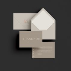 two business cards with the words thank you on them, and an envelope in front