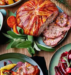 a table topped with plates filled with meat and veggies next to other foods