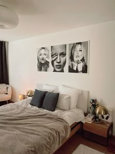 a bedroom with three black and white pictures on the wall