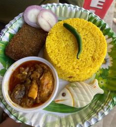 a paper plate topped with different types of food