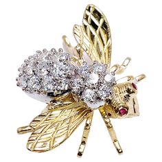 Absolutely stunning, excellent condition diamond brooch made in 18KT yelllow & white gold by Herbert Rosenthal. A rare find because this is the large version. CENTER STONE: NATURAL DIAMONDS CARAT: 1.55CT CLARITY: VS1-VS2 COLOR: F CUT: ROUND BRILLIANT OTHER GEMSTONE(S): 2 small round rubies 1.8mm GRAM WEIGHT: 9.90gr GOLD: 18KT yellow gold CLOSURE: pin MEASUREMENTS: 1.25 X 1 INCHES LONG DESIGNER: Herbert Rosenthal WHAT YOU GET AT STAMPAR JEWELERS: Stampar Jewelers, located in the heart of Jupiter, Florida, is a custom jewelry store and studio dedicated to providing 100% satisfaction to each client. Our personal attention to detail, passion, affordability and honesty set us apart from any other store. We will bring full catering of our services to you online through phone calls, consultations Bee Pin, Diamond Brooch, Pin Brooch, Jewelry Store, Round Brilliant, Jewelry Stores, Custom Jewelry, Brooch Pin, Natural Diamonds