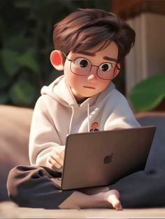 a young boy sitting on the ground with a laptop computer in front of his face