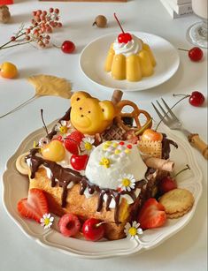 a white plate topped with cake covered in frosting and fruit next to other desserts