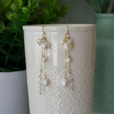 Elegant and sparkly dangle earrings with swarovski crystals and natural pearls. ❀ELEMENTS❀-14k Gold Filled Earring Hooks (Rubber safety backs included)-14k Gold Filled Wire and chain-Swarovski crystal bicone beads-Natural pearls in different shapes and sizes❀SIZE❀Approximately 3 inches long from top of ear wire to bottom of longest dangle❀PRODUCTION❀All of my earrings are handmade in small batches and each one is unique. Gemstones and pearls are natural and may vary in color, pattern, shape, and Sparkling Pearl Earrings For Gift, Crystal Pearl Drop Earrings As Gift, Sparkling Pearl Drop Earrings Gift, Crystal Pearl Drop Earrings For Gift, Delicate Pearl Drop Dangle Crystal Earrings, Elegant Metal Pearl Earrings With Dangling Beads, Pearl White Crystal Pearl Earrings For Gifts, Elegant Wire-wrapped Yellow Gold Pearl Earrings, Handmade 14k Gold-filled Dangle Pearl Earrings