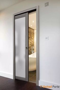 an open door leading to a bathroom with a tub