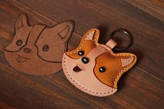 a leather keychain with an image of a cat on the front and back