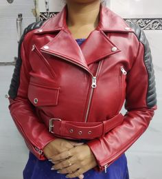 Materials: Sheepskin Leather Color : Red/Black  Closure : Zipper / Ykk Zipper  Front Zip Closure and Belt  Handmade: Yes  Season: Winter, Spring, Fall Occasion: Party, Halloween Style: Cropped Biker  Women's Real Sheepskin Crop Leather BIKER Jacket, Red & Black Combination SHRUG Celebrity Leather Jacket with QUILTED, Christmas Gift for her Handmade, Brilliantly designed, Professionally cut & Premium stitching throughout as per worldwide standards.  Handmade Motorcycle Red  Genuine Leather Jacket | Delicate women's leather jacket |  Motorcycle Black Jacket | Cropped Style Long Sleeves Red | Cropped Moto Bolero Shrug Biker Jacket | Cropped Motor Biker leather Jacket | Natural Soft Leather  Motor Biker Jacket Genuine Handmade Stylish Biker Leather Jacket For Her Slim-fit Long Sleeves, Fashion Silver Leather Jacket, Shrug Jacket, Black Combination, Celebrities Leather Jacket, Distressed Leather Jacket, Cotton Lycra Fabric, Pink Leather Jacket, Womens Black Leather Jacket, Biker Leather Jacket