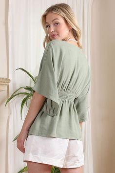 Lilou SS Deep V Neck Button Down Top Elevate your wardrobe with the Lilou SS Deep V Neck Button Down Top. This solid-colored blouse exudes elegance with its deep V neckline and kimono-style draped sleeves. Made from a comfortable cotton-linen blend in a sage color, it's perfect for any occasion. Functional buttons and a lined upper front ensure both beauty and practicality. Deep V Neckline Button Down Blouse with Draped Sleeves Pattern Type: Solid Color: Sage Neck Line: V-neck Sleeve Type: Kimon