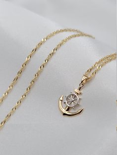 "14K Solid Gold Anchor Necklace. Unique Design With Ship Wheel. Singapore Chain 21 1/4\", 2mm. Unisex! Perfect Gift! Gram Weight: 3.85g (chain and pendant) The Chain is available for sale individually. Please message me for more details! Chain Length: 21 1/4 inches  Chain Thickness: 2 mm Chain Weight: 2.90g The Pendant is available for sale individually. Please message me for more details! Pendant Weight: 0.95g Pendant Length: 22mm Pendant Width: 15mm  * 14K gold will be marked with a number such as 585, or 14K stamp denoting that the jewelry contains 58.5% gold (or 585 parts per thousand). ALL MY JWELERIES ARE MADE OF HIGH QUALITY SOLID GOLD MATERIAL ONLY AND I DO NOT CARRY ANY ''GOLD PLATED MATERIAL'' ITEMS.  * We are pleased to offer complimentary delivery within the Canada and US. * Yo Chain And Pendant, Anchor Design, Anchor Necklace, Sea Design, Ship Wheel, Anchor Bracelet, Precious Jewels, Necklace Unique, Mens Pendant