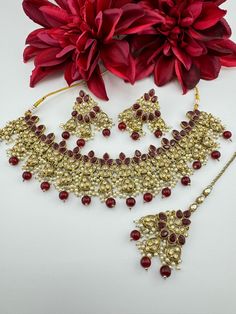 This is a beautiful Polki/Reverse AD Mehndi polish Maroon/Dark red Semi-bridal necklace set with matching long earrings and Tika has amazing shine. This is so beautiful to look at and a perfect one for Indian weddings.  Color : gold, Maroon/Red Necklace length : collar necklace length Necklace width :  Earring length : 2.5 inch Earring width : 1.75 inch Each Earring Weight: 12.8 Grams Material : Brass, Reverse AD, pearls Beautiful High Quality, premium jewelry. Free US standard shipping. Hand cr Bollywood Bridal Necklace With Tilla As A Gift, Chandbali Tilla Bridal Sets As Gift, Tilla Chandbali Bridal Set Gift, Bollywood Style Intricate Design Gift Sets, Bollywood Style Gift Sets With Intricate Design, Hand Set Bridal Necklace As Festive Gift, Festive Hand Set Bridal Necklace As A Gift, Bollywood Bridal Sets With Stone Work For Gifts, Festive Bridal Necklace With Latkans