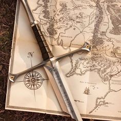 two swords laying on top of an old map