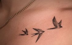 two birds flying in the air on top of a woman's chest