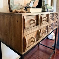 an old wooden dresser with books on top