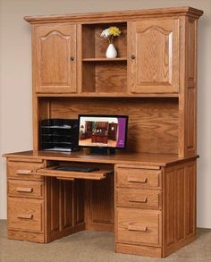 a wooden desk with drawers and a computer monitor