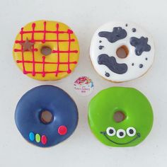 four donuts with different designs on them sitting next to each other