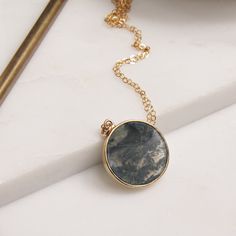 Moss agate round pendant necklace on 14k gold filled dainty chain / Moss jewelry / Unique jewelry gifts for her / Gold jewelry and pendants Stone: Genuine Moss Agate Stone: 20mm diameter Gold chain: 14k gold filled Chain length: 16-18 inches (adjustable) Clasp: spring ring Bezel: Vermeil Gold Arrives in gift box Made in the USA About "Gold Filled Jewelry": Also called rolled-gold. These jewelry items are not actually filled with gold. They are made of a base metal covered by sheets of gold in a Tiny Pendant Necklace, Moss Jewelry, Moss Agate Stone, Beautiful Pendant Necklace, Soldered Jewelry, Unique Jewelry Gifts, Ring Bezel, Round Pendant Necklace, Dainty Chain