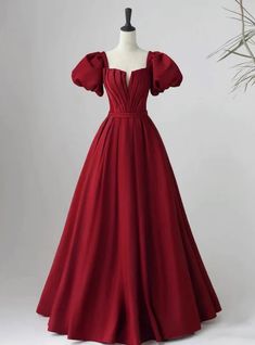 Garnet elegance in dress form �?isn't this what fairy tales are made of? Imagine stepping into the ballroom, the rich, red hue of this prom dress making a bold statement, as timeless as it is modern. This exquisite gown is designed for those who seek a blend of classic charm and contemporary flair. Its off-the-shoulder puff sleeves add a touch of regal sophistication, while the fitted bodice beautifully transitions into a soft gathering at the waist, accentuating the silhouette. The full A-line skirt, crafted from flowing fabric, cascades to the ground, creating an air of majestic grace with each step. Perfect for prom, this dress promises to be a cherished ensemble that speaks volumes of your impeccable taste and confidence. Royal Prom, Poofy Dresses, Brown Prom Dresses, Champagne Homecoming Dresses, Yellow Homecoming Dresses, Prom Dress Burgundy, Purple Homecoming Dress, Burgundy Homecoming Dresses, Orange Prom Dresses