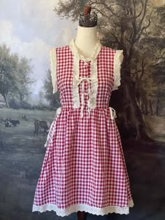 Transport yourself to a charming countryside cottage with our vintage-style red gingham mini dress! Inspired by historical fashion, this dress features delicate ivory lace trim, a button-up bodice, ribbon cinching ties, and a gathered skater silhouette. Sizing: ✧IN Bust Waist Length S 34-35 In. 34-35 In. 34 In. M 36-37 In. 36-37 In. 34.5 In. L 38-40 In. 38-40 In. 35 In. ✧CM Bust Waist Length S 85-87.5 cm 85-87.5 cm 85 cm M 90-92.5 cm 90-92.5 cm 86 cm L 95-97.5 cm 95-97.5 cm 87.5 cm Materials:Outer - 100% CottonLining - 97% Polyester, 7% Spandex Care:Hand wash with color-catcher. Air dry laying flat or hanging. Art Teacher Outfits, Gingham Mini Dress, Blue Gingham Dress, Countryside Cottage, 2023 Clothing, Medieval Fashion, Red Gingham, Love Clothing, Edwardian Fashion