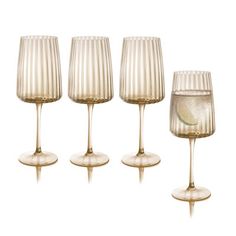 four wine glasses are lined up in a row