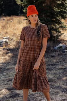 The Seen the Rain Gingham Tiered Dress is perfect for every stage of life. It has a round neckline, tiered skirt, and keyhole back with button closure. We love it paired with boots and a beanie for this Winter season! pockets Overall Dress Outfit Winter, Saddle Brown, Boho Dresses, Gingham Dress, Tier Skirt, Overall Dress, Tiered Dress, Tiered Skirt, Winter Season